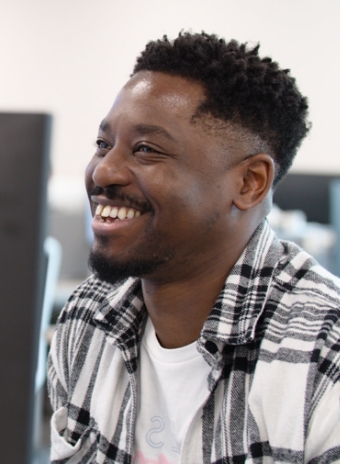 A man smiling in the cinch office