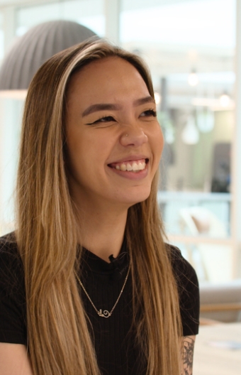 A woman smiling in the cinch office